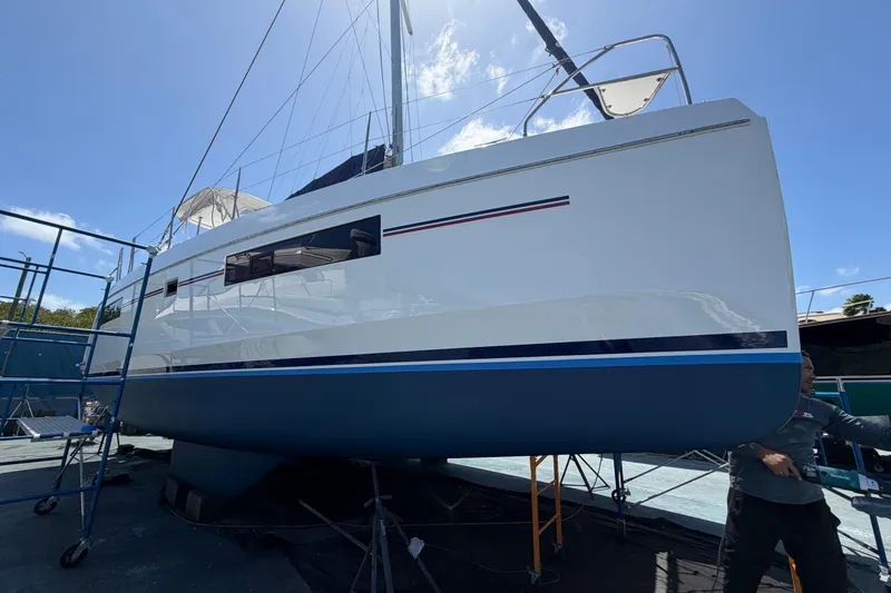 Slide: The Image of 2018 Leopard 40 catamaran on dry dock, undergoing maintenance under clear blue sky. - 31