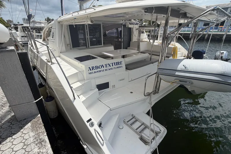 Slide: The Image of 2018 Leopard 40 catamaran docked, featuring spacious deck and dinghy at Melbourne Beach, Florida. - 32