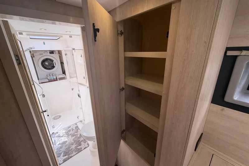 Slide: The Image of Interior of 2018 Leopard 40 yacht featuring bathroom with washer and storage shelves. - 33