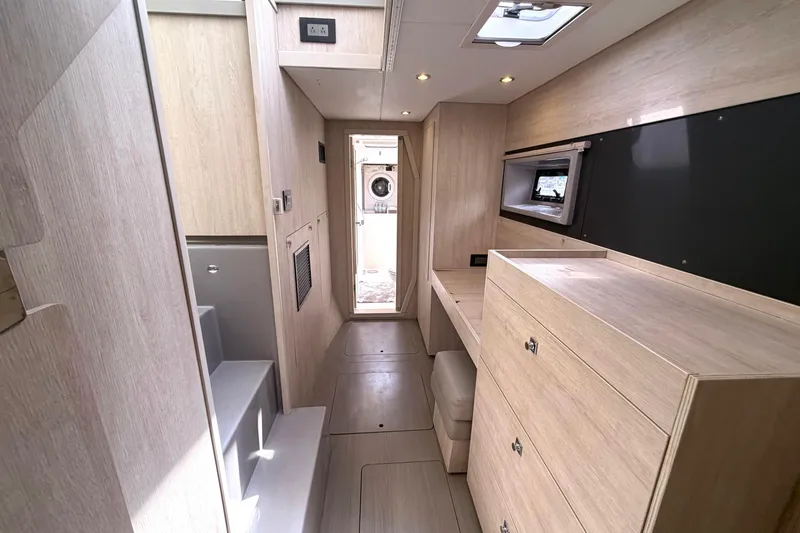 Slide: The Image of Interior of 2018 Leopard 40 yacht with modern wood finish and built-in storage. - 34