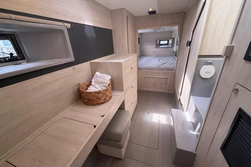 Slide: The Image of Interior of 2018 Leopard 40 catamaran featuring a cozy cabin with modern wood finishes. - 35