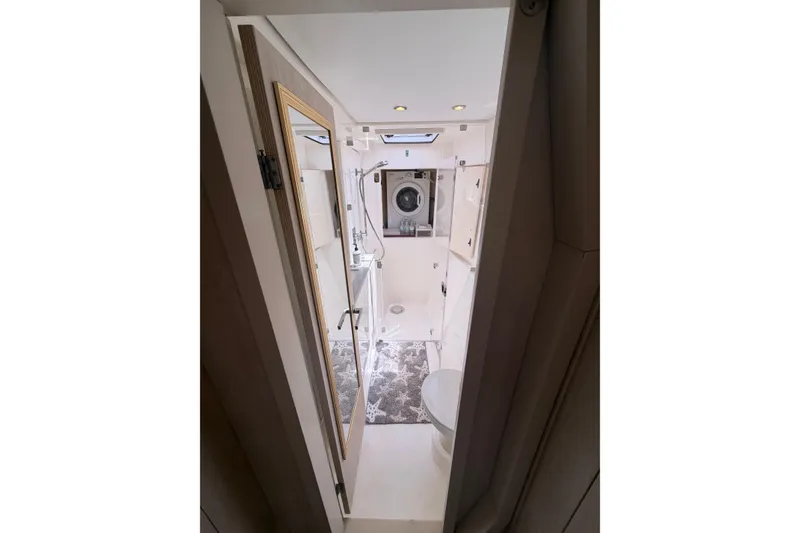 Slide: The Image of Bathroom interior of 2018 Leopard 40 catamaran, featuring modern fixtures and washing machine. - 36