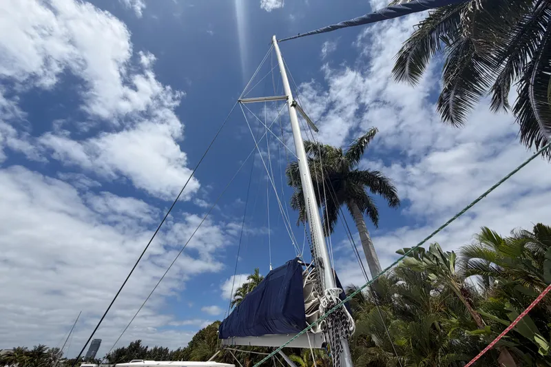 Slide: The Image of Sailboat mast of 2018 Leopard 40 against blue sky and palm trees. - 39