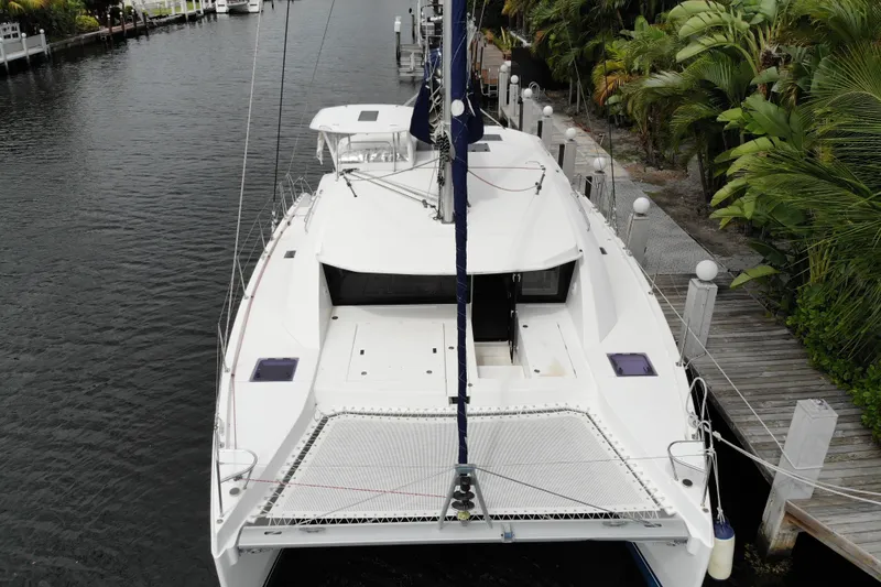 Slide: The Image of 2018 Leopard 40 catamaran docked by lush greenery and calm waterway. - 4