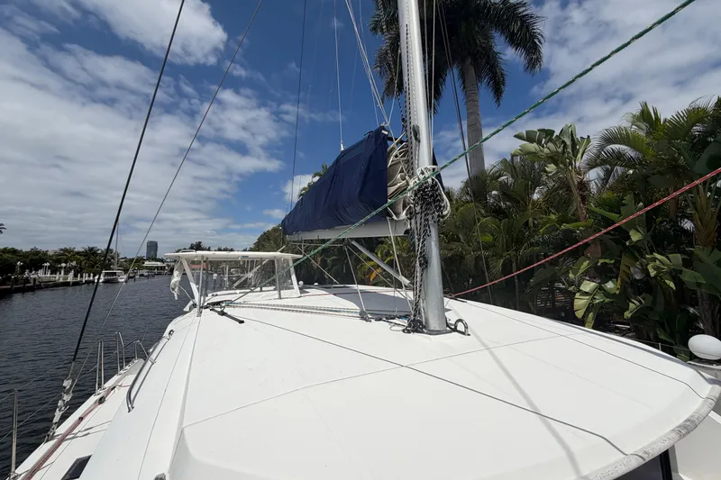 Slide: The Image of 2018 Leopard 40 catamaran docked by palm trees under a partly cloudy sky. - 40