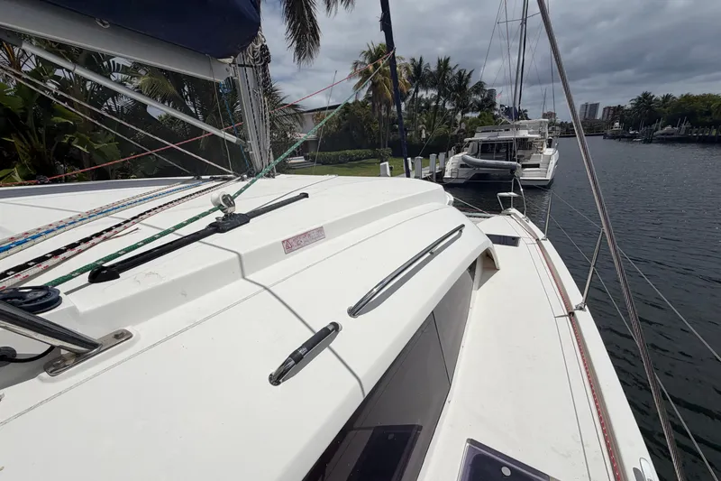 Slide: The Image of 2018 Leopard 40 catamaran docked by palm trees and waterway. - 43