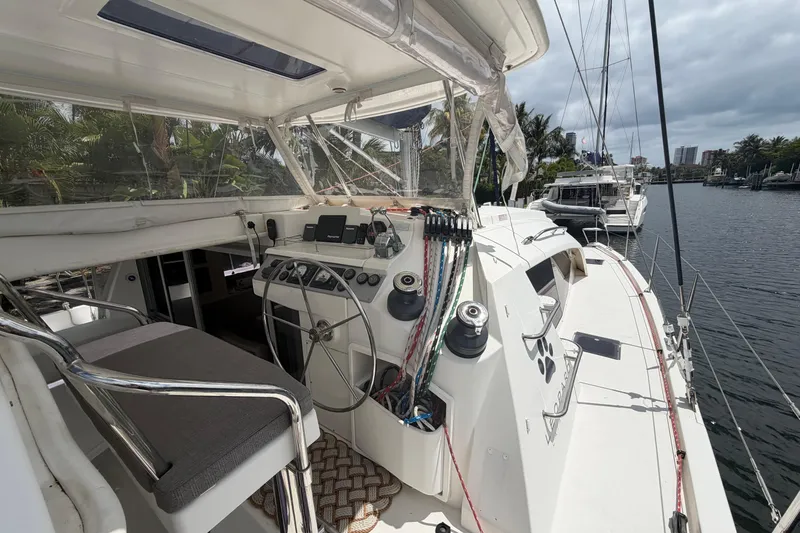 Slide: The Image of Cockpit view of a 2018 Leopard 40 catamaran docked by a scenic waterfront. - 44
