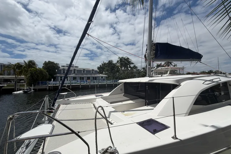 Slide: The Image of 2018 Leopard 40 catamaran docked by waterfront, under a partly cloudy sky. - 45