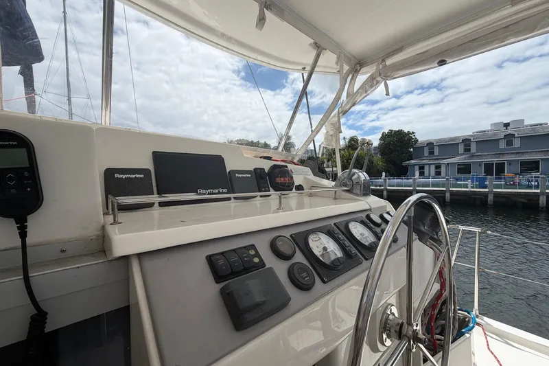 Slide: The Image of Cockpit of 2018 Leopard 40 catamaran with Raymarine navigation equipment and steering wheel. - 52