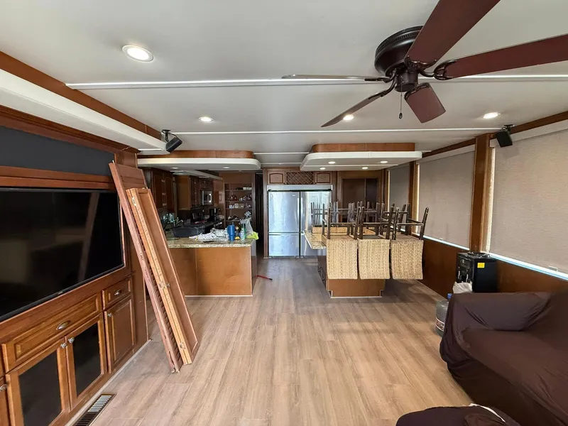 Slide: The Image of Interior of 2011 Bravada Dream Weaver Trip 14 with modern kitchen and living area. - 15