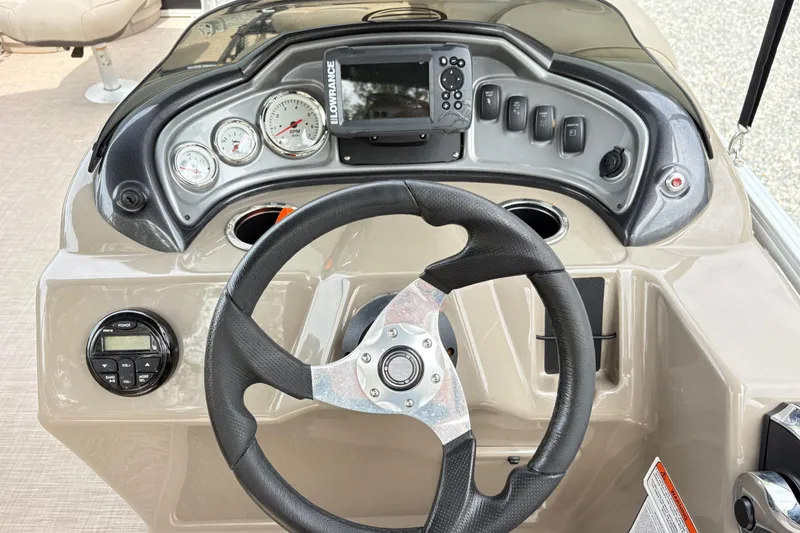 Slide: The Image of Dashboard of a 2021 Sun Tracker Fishin' Barge 20 DLX with steering wheel and gauges. - 13
