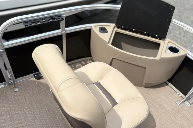 Slide: The Image of 2021 Sun Tracker Fishin' Barge 20 DLX interior with beige seating and console. - 17