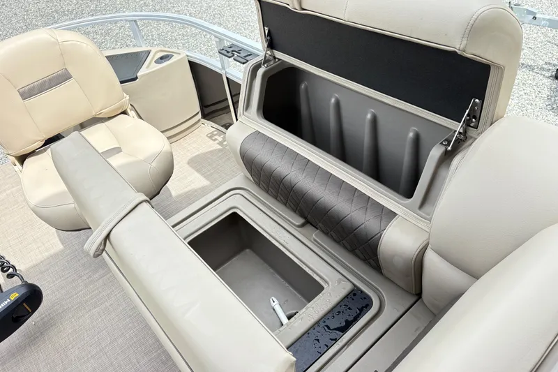 Slide: The Image of 2021 Sun Tracker Fishin' Barge 20 DLX interior with storage compartments and seating. - 18