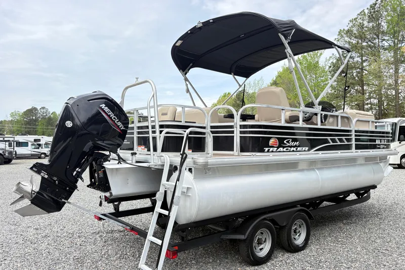 Slide: The Image of 2021 Sun Tracker Fishin' Barge 20 DLX pontoon boat with Mercury outboard motor. - 2