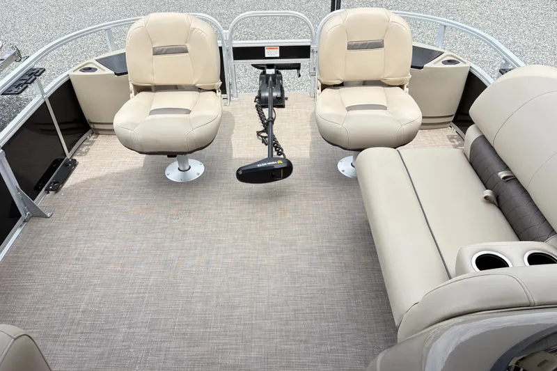 Slide: The Image of 2021 Sun Tracker Fishin' Barge 20 DLX interior with beige seating and fishing equipment. - 5