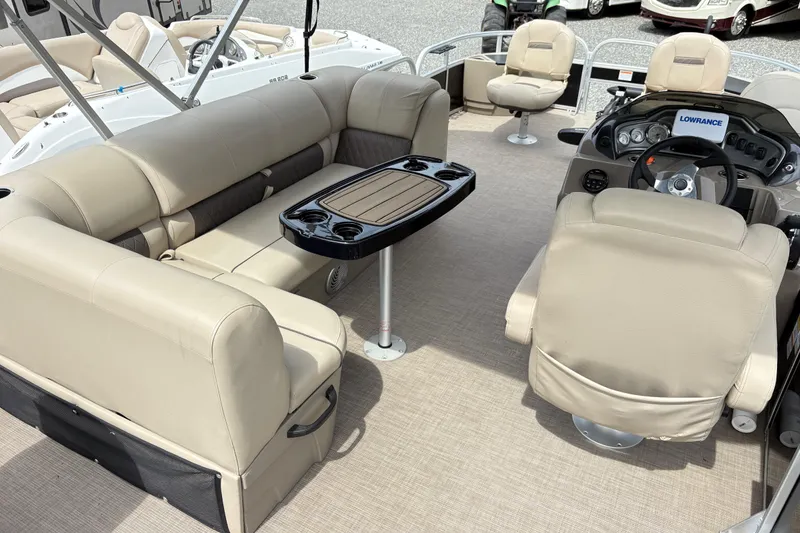 Slide: The Image of 2021 Sun Tracker Fishin' Barge 20 DLX interior with beige seating and steering console. - 6