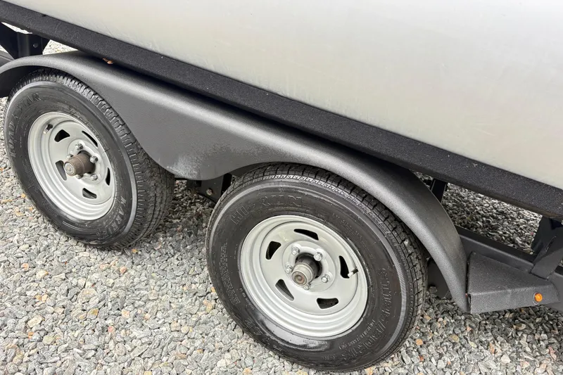Slide: The Image of Trailer wheels of a 2021 Sun Tracker Fishin' Barge 20 DLX on gravel. - 9