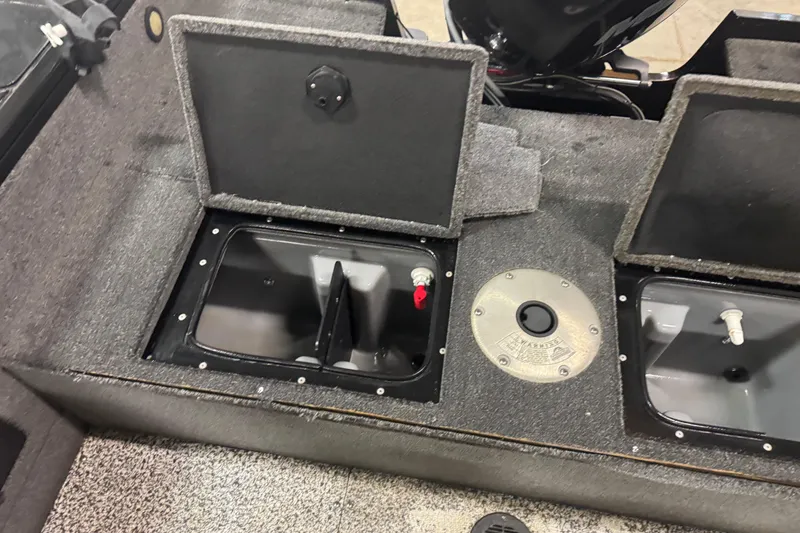 Slide: The Image of 2014 Tracker Targa V-18 WT boat interior with open storage compartments. - 12