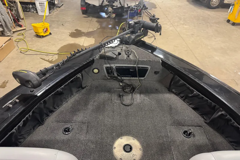 Slide: The Image of 2014 Tracker Targa V-18 WT boat interior with trolling motor and carpeted deck. - 13