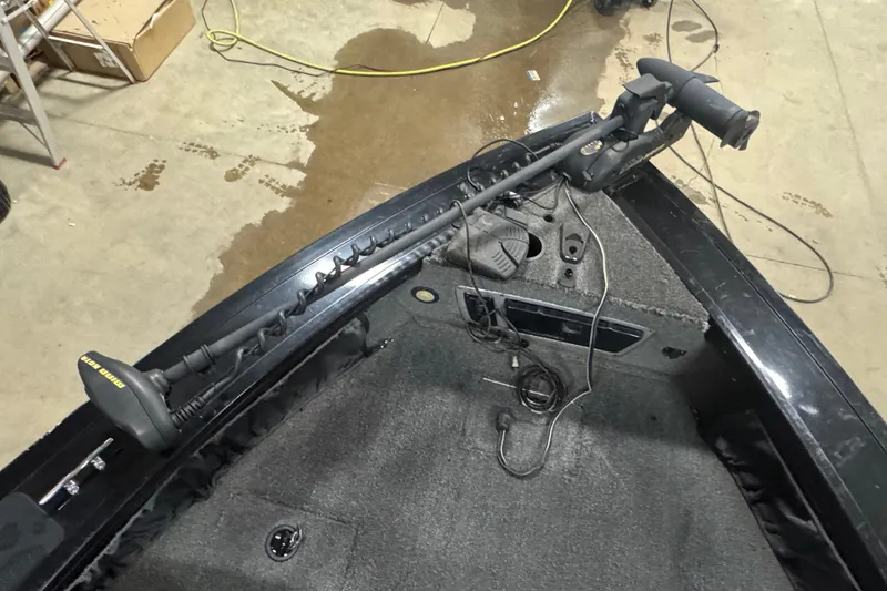 Slide: The Image of 2014 Tracker Targa V-18 WT boat interior with trolling motor and carpeted deck. - 14