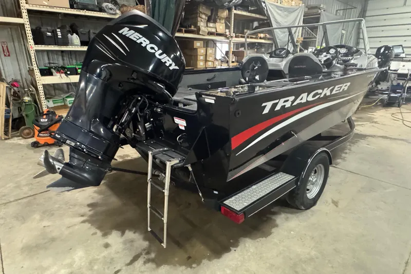 Slide: The Image of 2014 Tracker Targa V-18 WT boat with Mercury engine in a garage setting. - 4