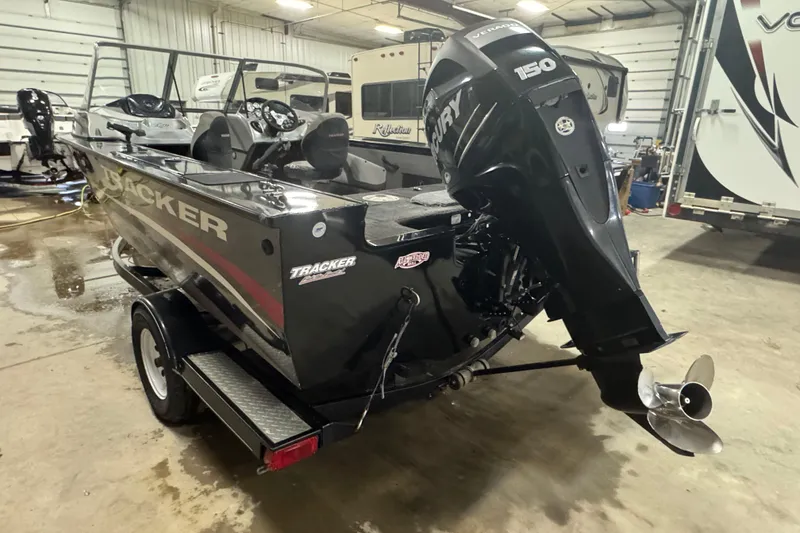Slide: The Image of 2014 Tracker Targa V-18 WT boat with Mercury 150 engine in a garage setting. - 5