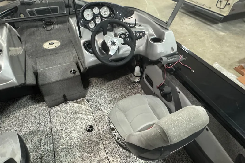Slide: The Image of 2014 Tracker Targa V-18 WT boat interior with steering wheel and dashboard controls. - 6