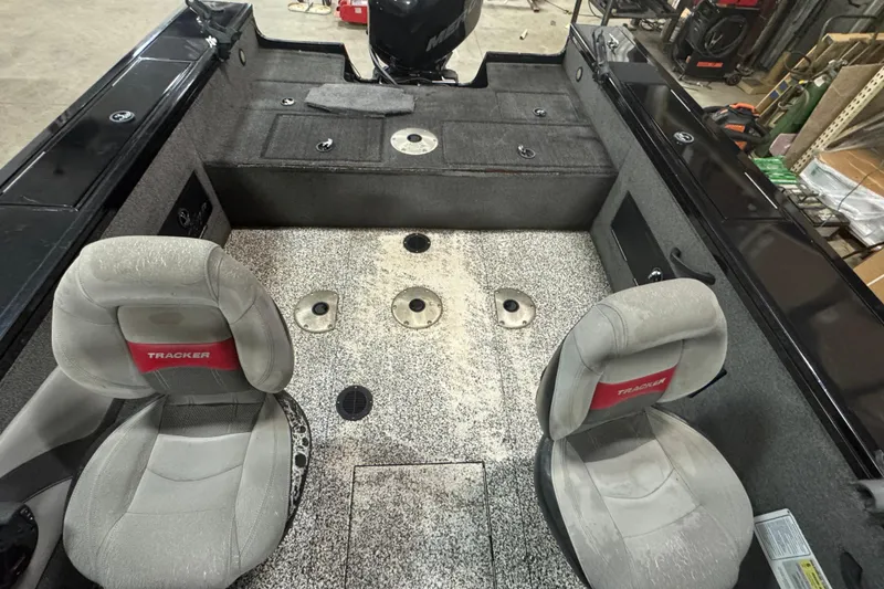 Slide: The Image of 2014 Tracker Targa V-18 WT boat interior with two seats and carpeted flooring. - 9