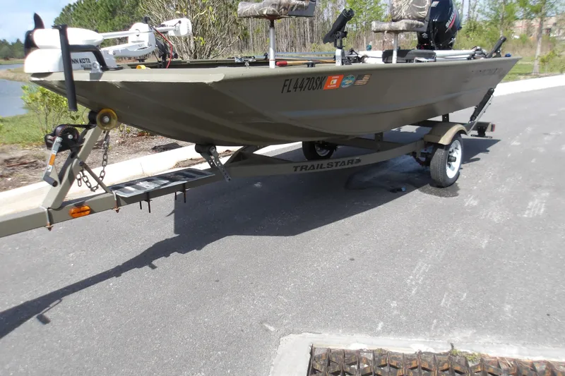 Slide: The Image of 2019 Tracker Grizzly 1448 Jon boat on a trailer, parked on a road. - 3