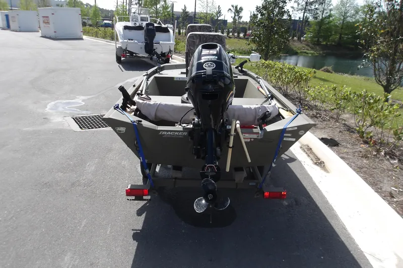 Slide: The Image of 2019 Tracker Grizzly 1448 Jon boat on trailer, parked near a pond. - 5