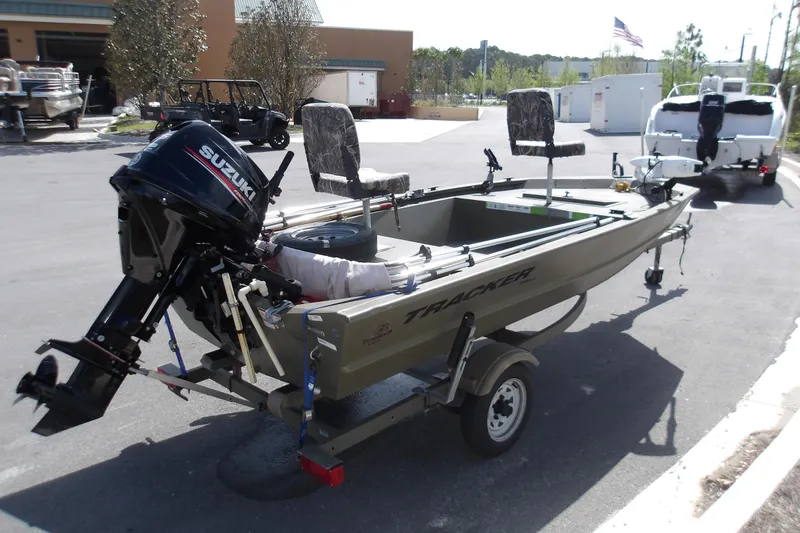 Slide: The Image of 2019 Tracker Grizzly 1448 Jon boat with Suzuki outboard motor on trailer. - 6