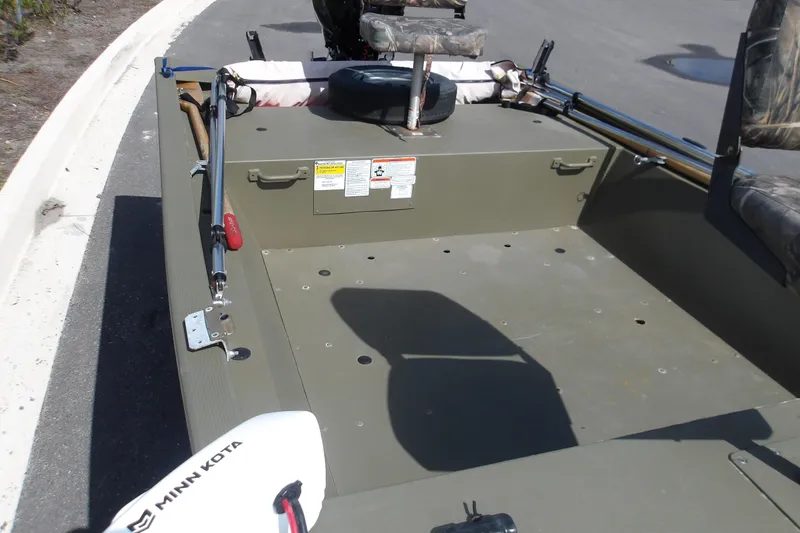 Slide: The Image of 2019 Tracker Grizzly 1448 Jon boat with Minn Kota motor on pavement. - 8