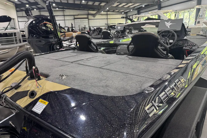 Slide: The Image of 2026 Skeeter ZXE21 boat in showroom, featuring sleek design and modern controls. - 13