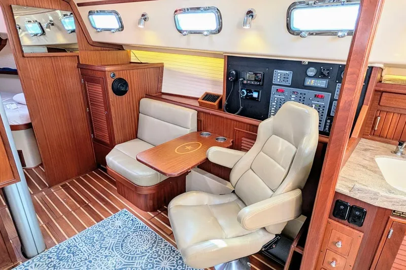 Slide: The Image of Interior of 1999 Island Packet 349 yacht with navigation station and seating area. - 11