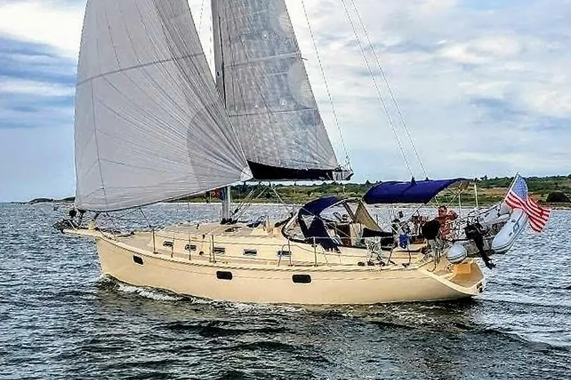 Slide: The Image of Sailing yacht Island Packet 349, 1999 model, cruising on open water with sails unfurled. - 20