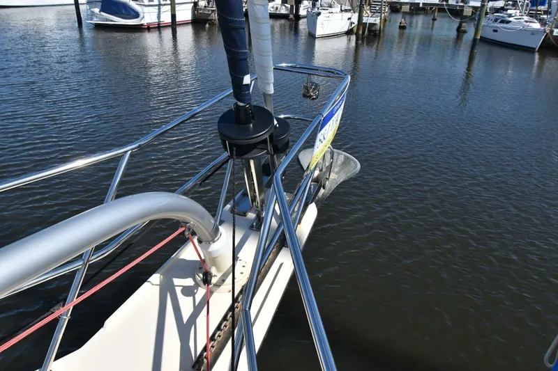 Slide: The Image of Bow of 1999 Island Packet 349 sailboat docked in marina, featuring anchor and railing. - 3