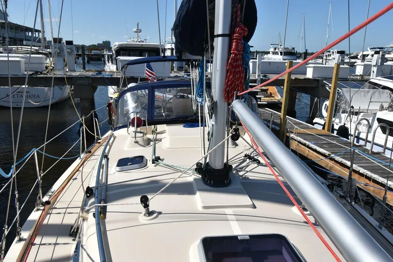 Slide: The Image of Island Packet 349 sailboat from 1999 docked at a marina, showcasing deck and rigging. - 4
