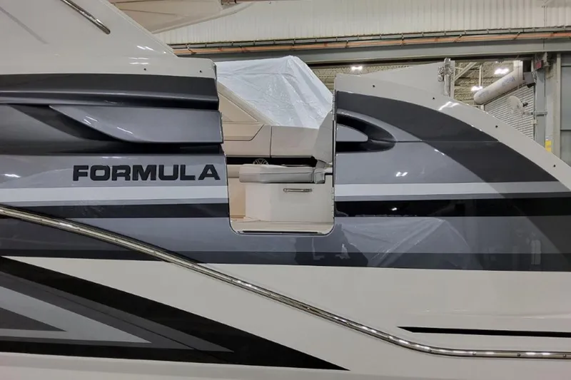 Slide: The Image of 2026 Formula 360 Crossover Bowrider I/O, sleek design, partial interior view, in a showroom. - 2