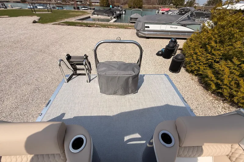 Slide: The Image of 2026 Tahoe Pontoon Cascade Quad Lounger, 25-foot model, docked with covered motor. - 14