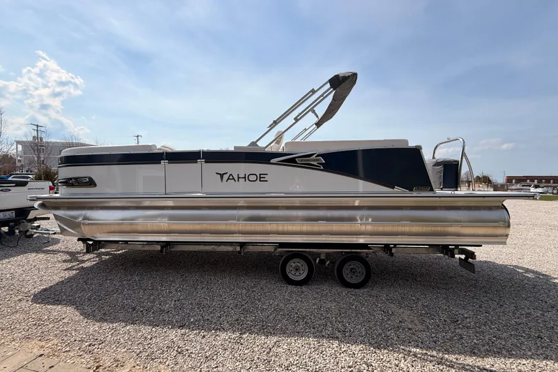 Slide: The Image of 2026 Tahoe Pontoon Cascade Quad Lounger 25' on trailer, parked outdoors. - 8