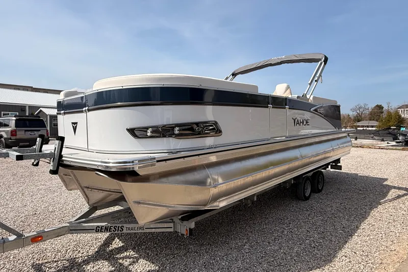 Slide: The Image of 2026 Tahoe Pontoon Cascade Quad Lounger 25' on Genesis trailer, parked on gravel. - 9