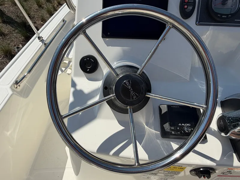 Slide: The Image of Steering wheel of 2024 Boston Whaler 150 Montauk with JL Audio system. - 10