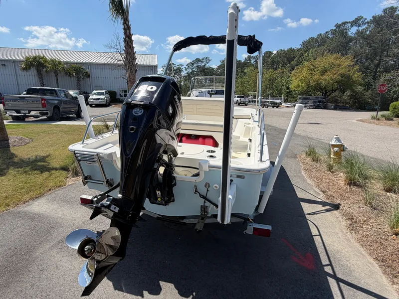 Slide: The Image of 2024 Boston Whaler 150 Montauk with outboard motor, parked on a trailer. - 3