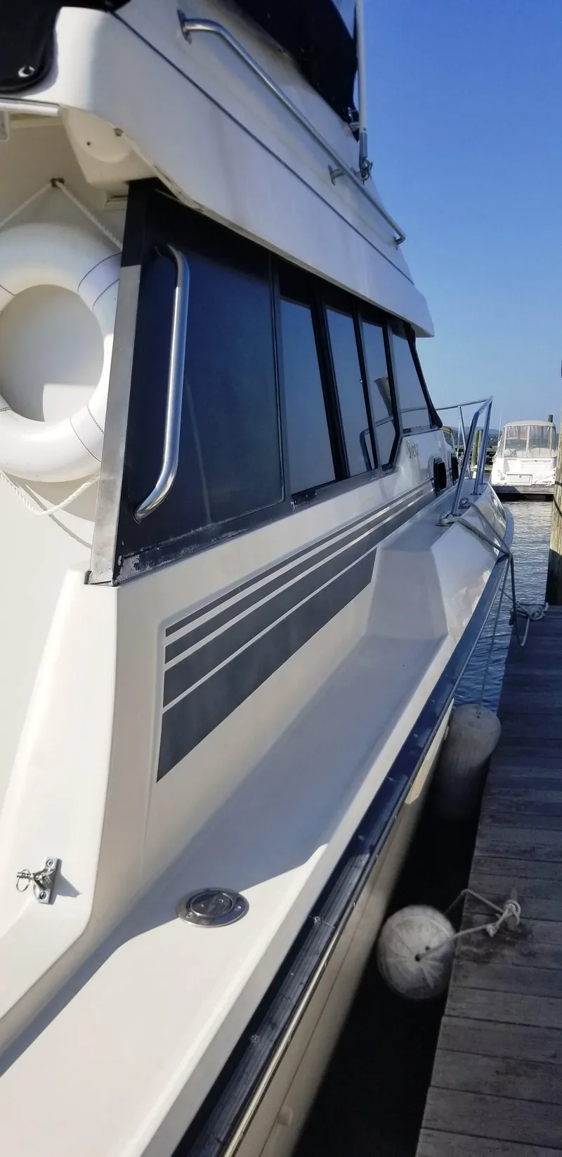 Slide: The Image of 1989 Silverton 34 Convertible yacht docked at marina. - 3