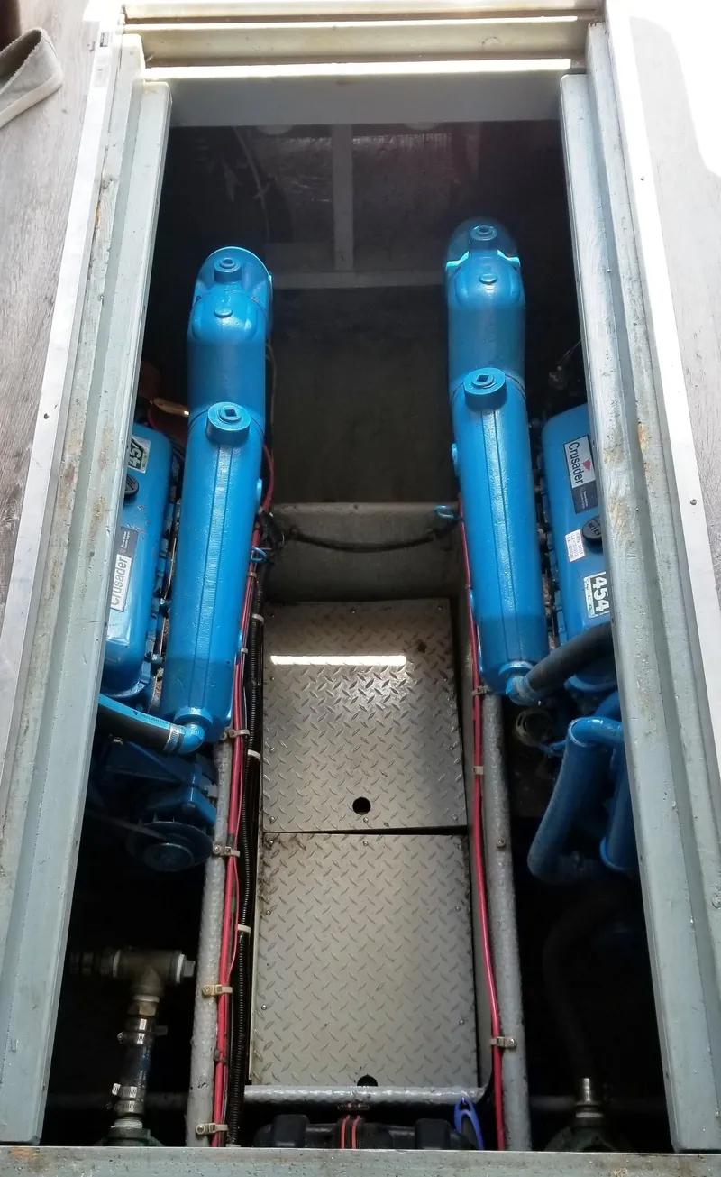Slide: The Image of Engine room of a 1989 Silverton 34 Convertible boat with blue engines. - 8