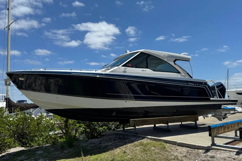 The Image of 2024 Formula 380 Super Sport Crossover OB boat on display under a clear blue sky. - 0