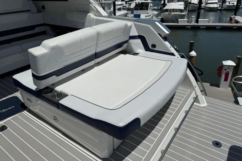 Slide: The Image of 2024 Formula 380 Super Sport Crossover OB boat with luxurious seating at marina. - 13