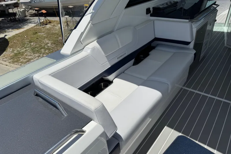 Slide: The Image of 2024 Formula 380 Super Sport Crossover OB boat interior with sleek seating and modern design. - 14