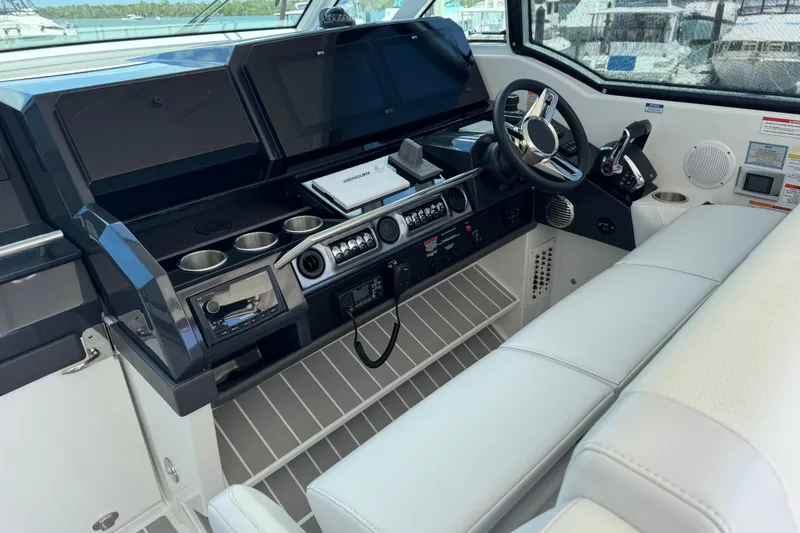 Slide: The Image of 2024 Formula 380 Super Sport Crossover OB helm with modern controls and navigation screens. - 19