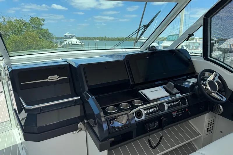 Slide: The Image of 2024 Formula 380 Super Sport Crossover OB helm with modern controls and navigation screens. - 21